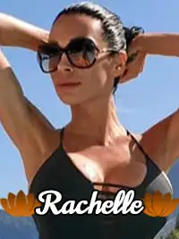 Woman in sunglasses posing outdoors with mountains