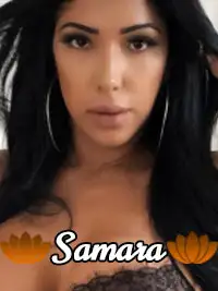 Portrait of woman with long hair, hoop earrings, and lace clothing